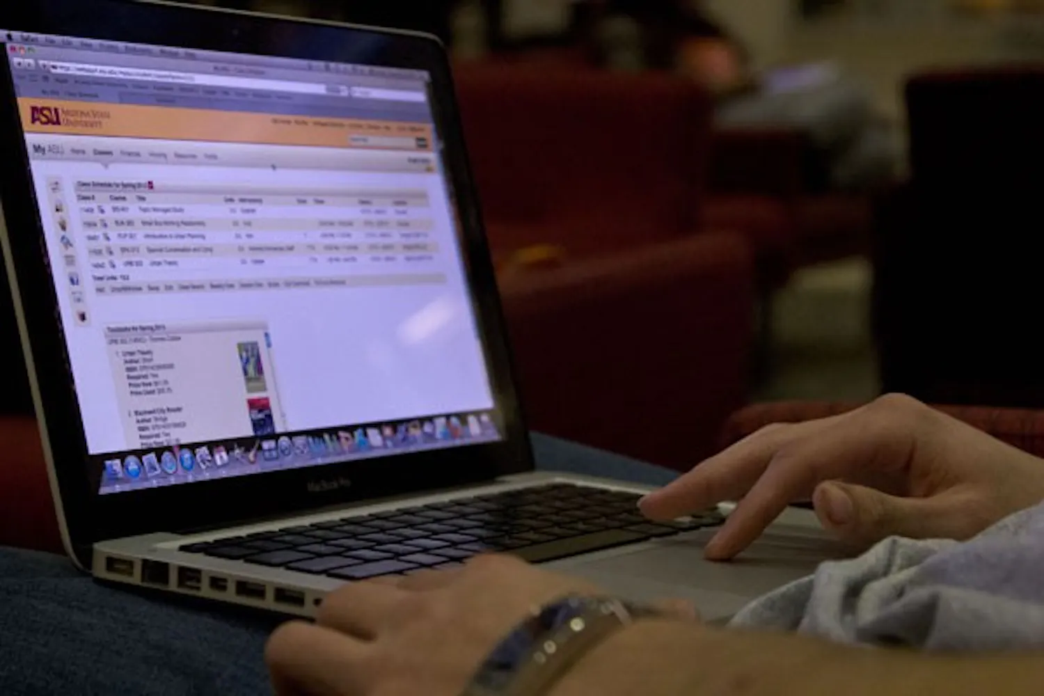 Business and urban planning senior Adam Daha sits on the first floor of the University Center looking at his ASU account. MyASU underwent a redesign over the course of winter break. (Photo by Ana Ramirez)
