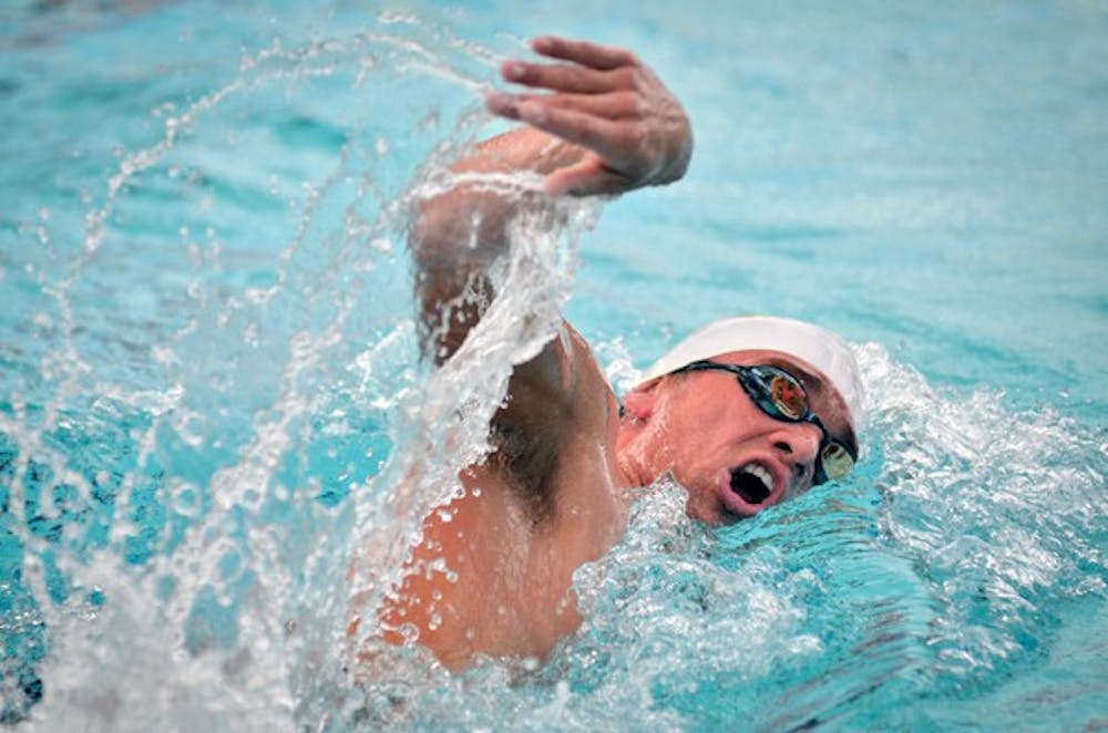 Junior Hayden Thomas gasps for air during his distance freestyle heat on Nov. 5, 2011, against Wisconsin. The swim and dive team took a breather during its break but is now focusing on its Jan. 11 meet versus BYU.
