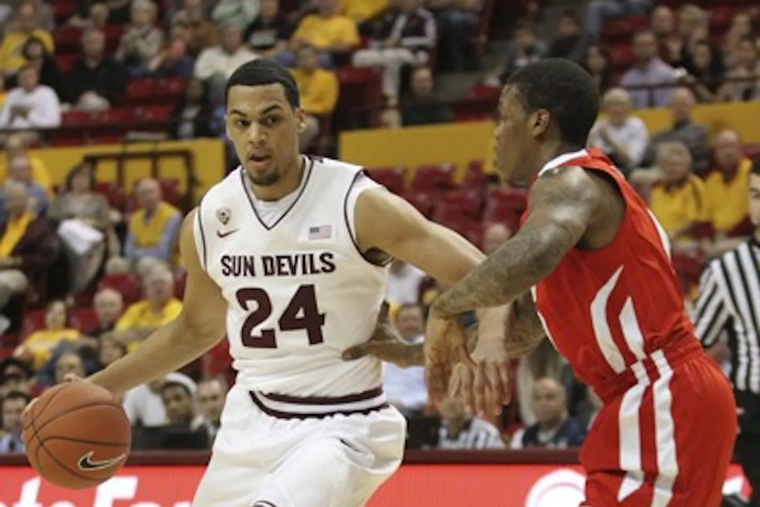 Trent Lockett dribbles the ball in the paint in a game against Utah Feb. 9. Lockett’s ankle continues to improve, but coach Herb Sendek is unsure if it will be completely healed this season. (Photo by Sam Rosenbaum)