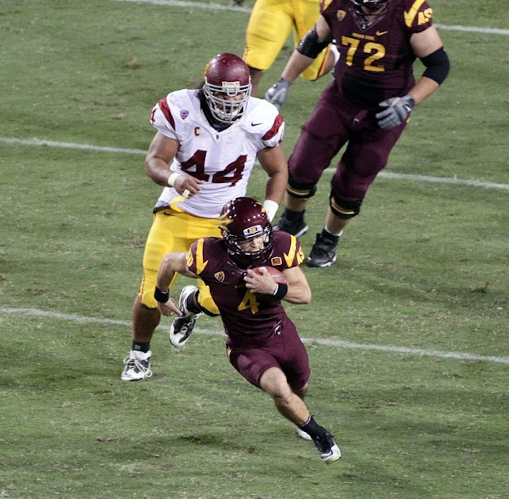 TAKING THE LEAD: Senior wide receiver Aaron Pflugrad carries the ball in the open field from USC defensive tack Christian Tupou during the Sun Devils’ 43-22 victory over the Trojans on Sept. 24. Pflugrad and the Sun Devils look to further secure their Pac-12 South lead Saturday against Utah. (Photo by Beth Easterbrook)