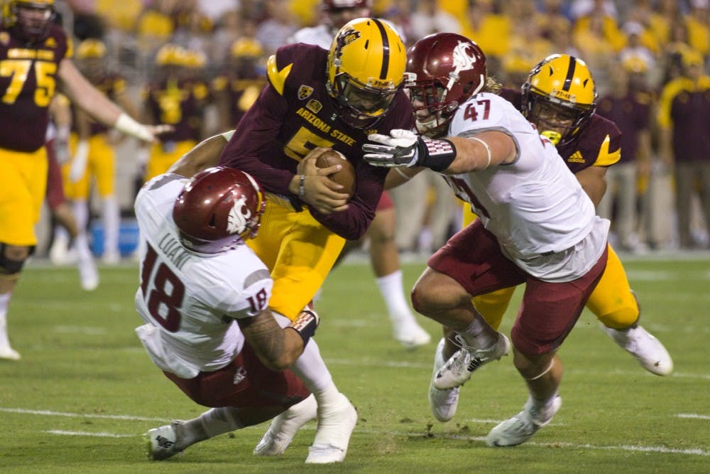 ASU redshirt sophomore quarterback Manny Wilkins (5) is hit, resulting in a sack, in the first half of a game versus WSU in Sun Devil Stadium in Tempe, Arizona, on Saturday, Oct. 22, 2016.