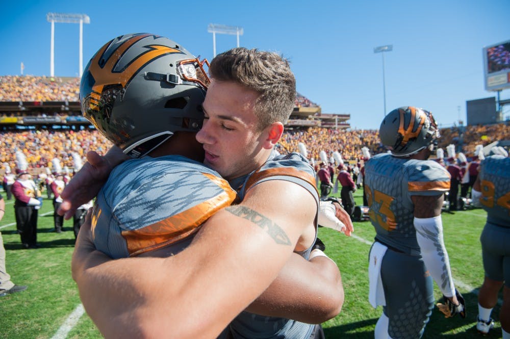 Redshirt senior defensive back Jordan Simone (38) hugs teammates before a game against UA on Saturday, Nov. 21, 2015, at Sun Devil Stadium in Tempe.