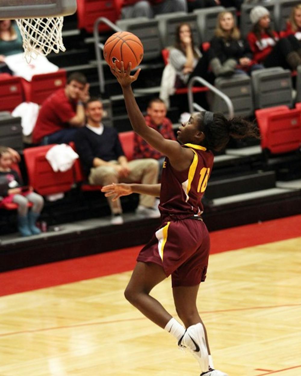 Promise Amukamara performs a layup in a game against Washington State on Jan. 26. Amukamara will be cheering for her brother Prince, cornerback for the New York Giants, in Super Bowl XLVI. (Photo courtesy of Steve Rodriguez)