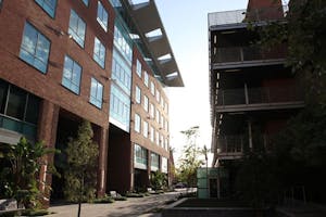 SINKING SUN: The setting sun tries to shine through the corridor located between the Foundation building and the Foundation parking garage. (Photo by Nikolai de Vera)