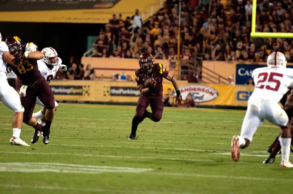 Junior running back D.J. Foster makes a dash with the ball. ASU beat Stanford 26-10 at Sun Devil Stadium on Saturday Oct. 8, 2014. (Photo by Mario Mendez)