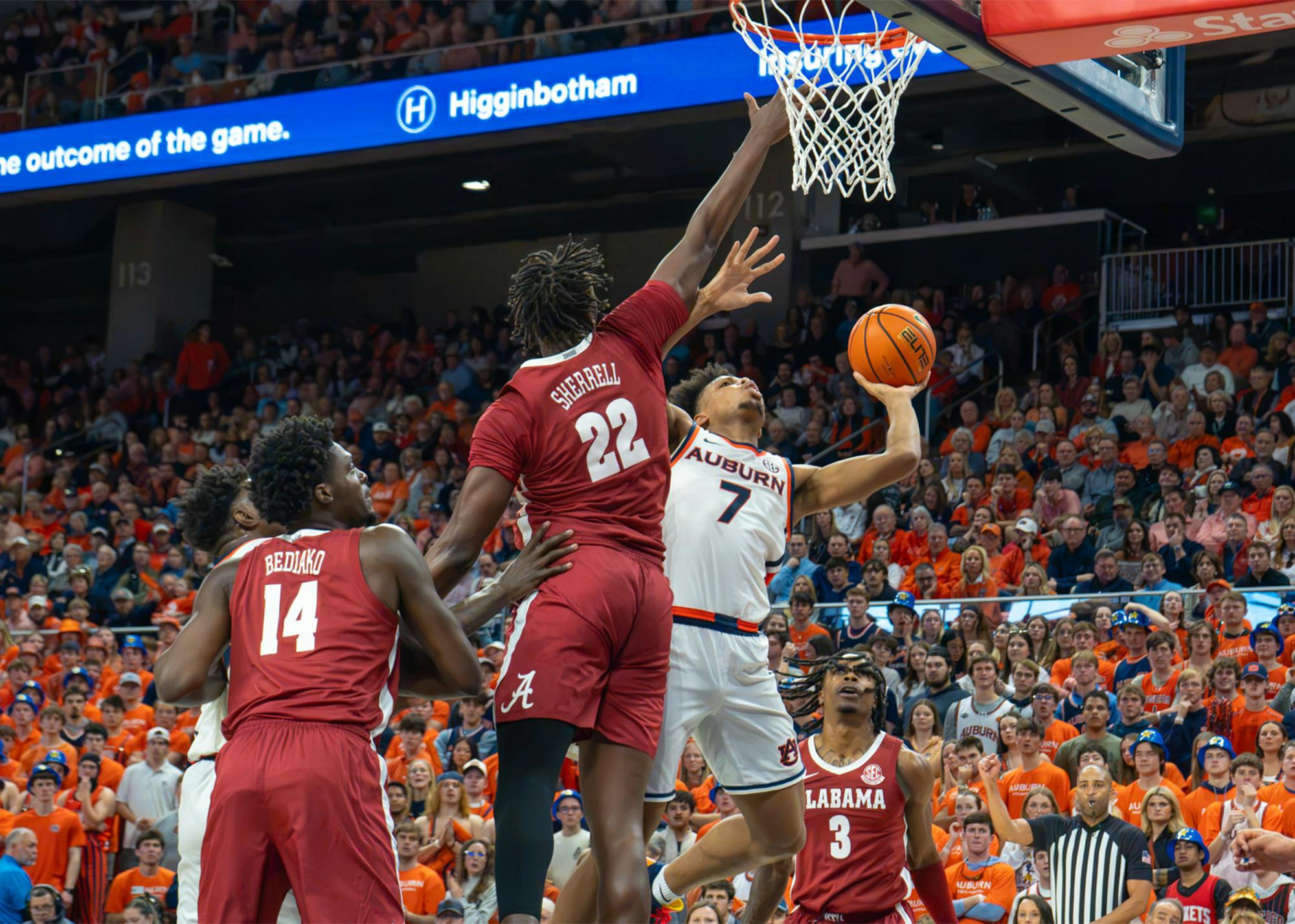 Auburn guard drives toward the basket for a layup as two Alabama defenders contest the shot during last season’s Iron Bowl at Auburn.