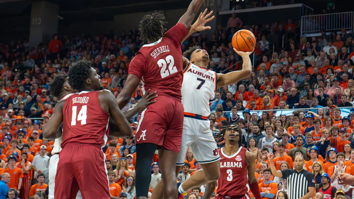 Auburn guard drives toward the basket for a layup as two Alabama defenders contest the shot during last season’s Iron Bowl at Auburn.