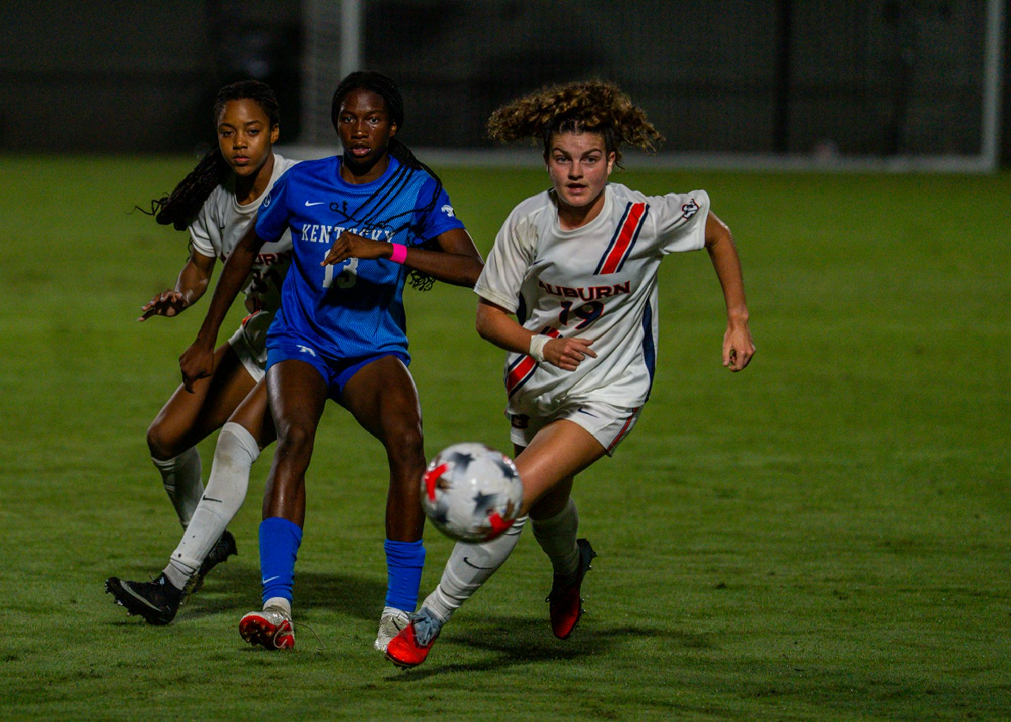 Auburn’s Kennedy Husbands (right) battles a Kentucky player for possession during Thursday night’s 1-1 draw at the Auburn Soccer Complex.