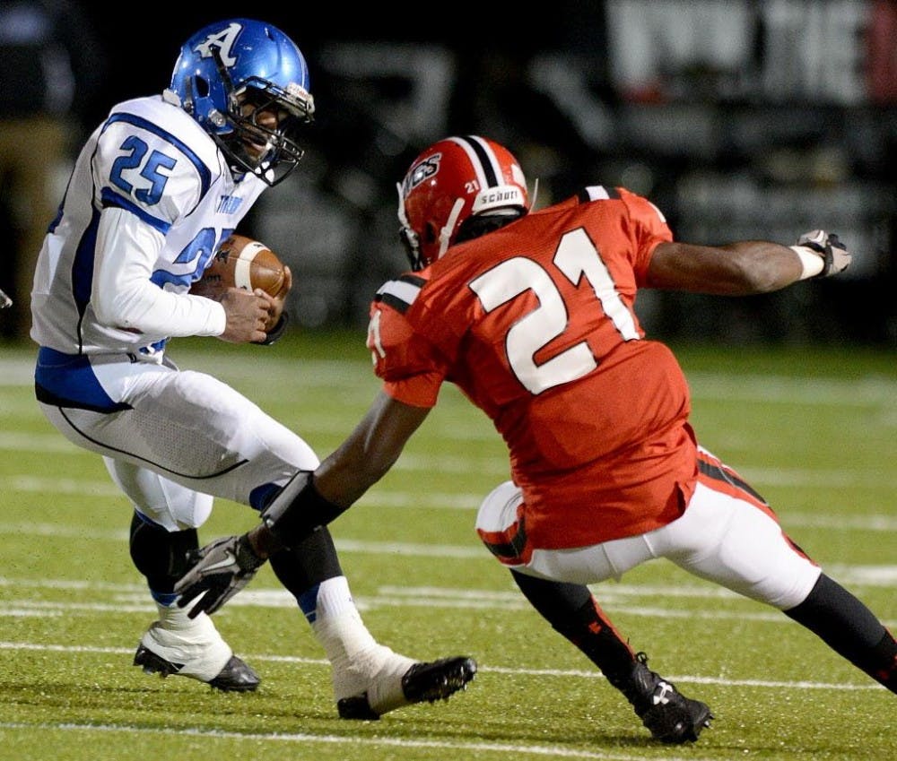 ​Auburn High's Tyus Flakes (25) avoids Opelika's Lequan Glenn (21)