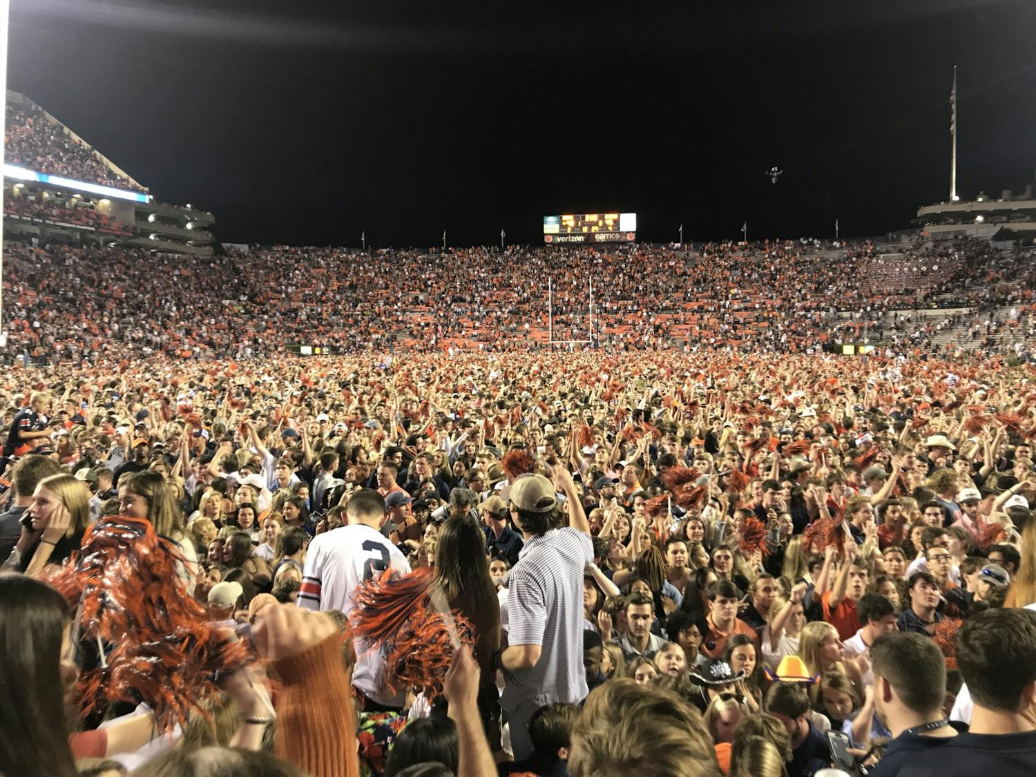Auburn fans storm the field after winning the Iron Bowl