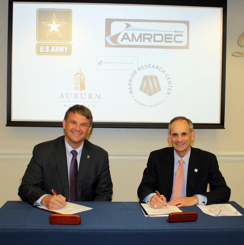 Jeff Langhout , left, acting technical director of the U.S. Army’s Aviation and Missile Research, with John Mason, Auburn’s vice president for research and economic development