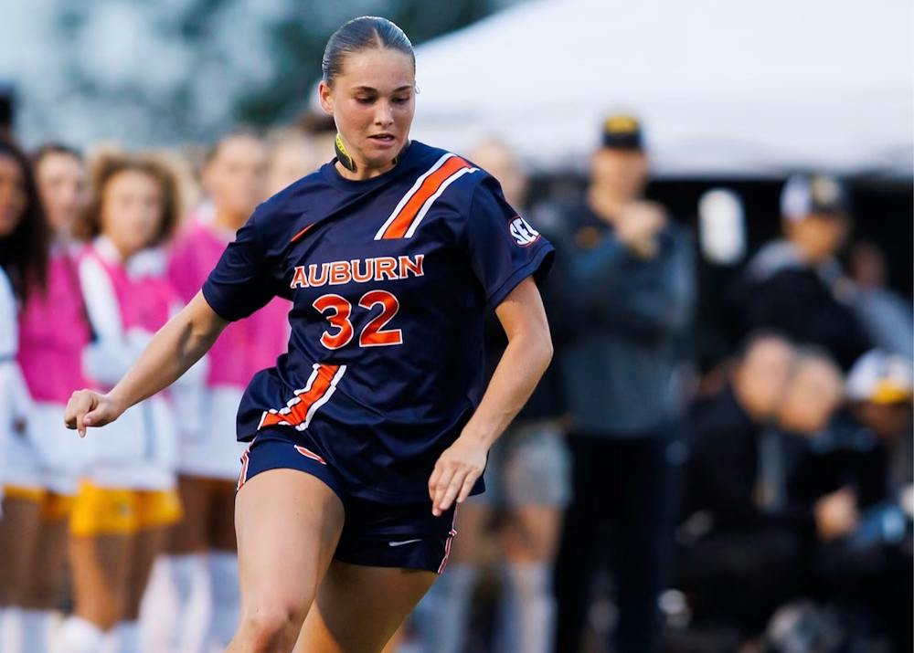 Auburn soccer player Kelly Gordon, wearing No. 32, dribbles the ball during a match.
