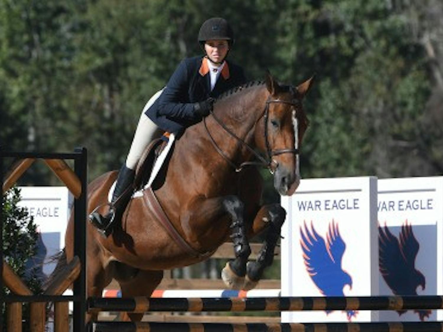 Auburn rider jumps over fence