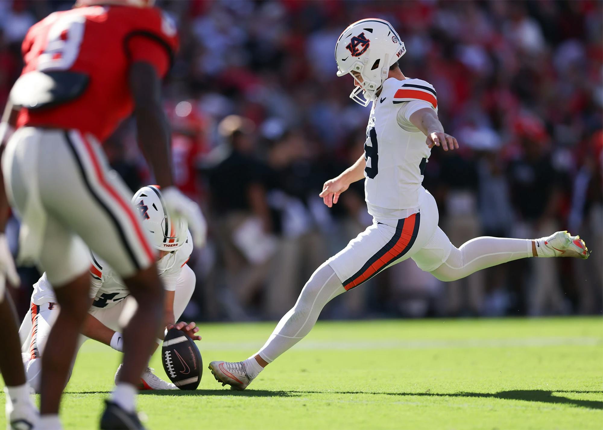 Auburn kicker Alex McPherson kicks the football during a game against Georgia at Sanford Stadium.
