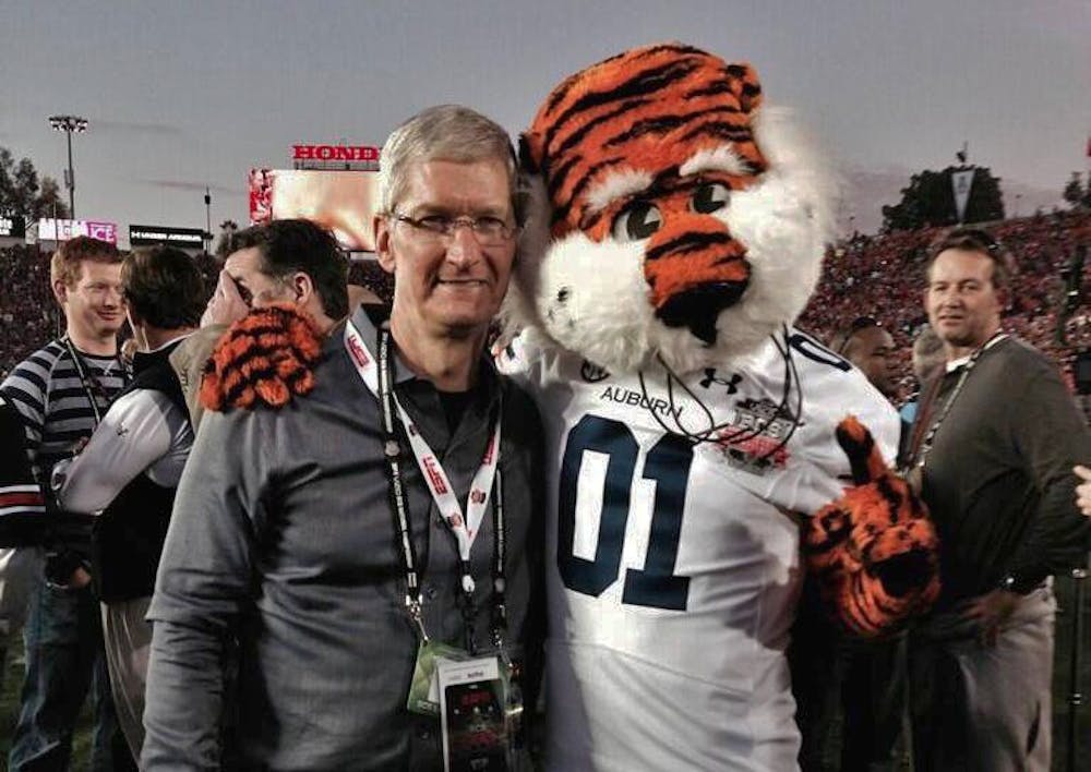 Tim Cook at Auburn with Aubie on the football field