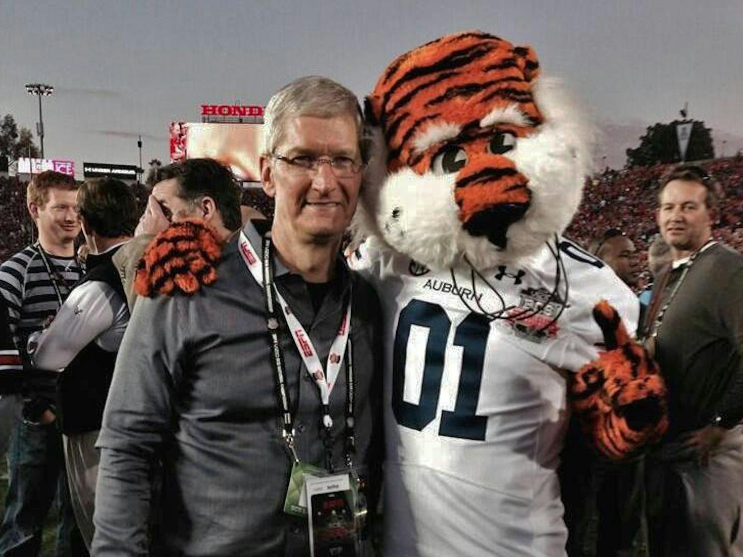 Tim Cook at Auburn with Aubie on the football field