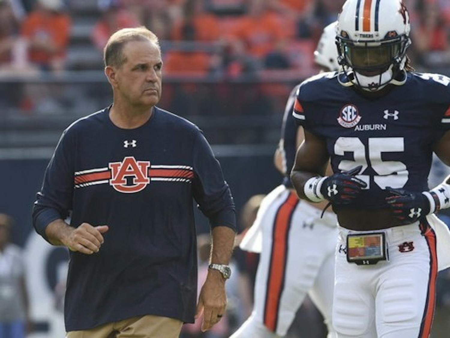 ​Kevin Steele (left) prepares his team before game against Mississippi State