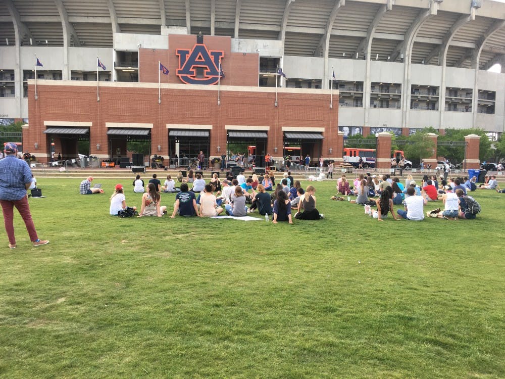 ​Students sit on the Green Space in protest of Richard Spencer.