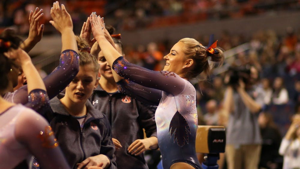 ​Auburn Gymnast gives high-fives to teammates