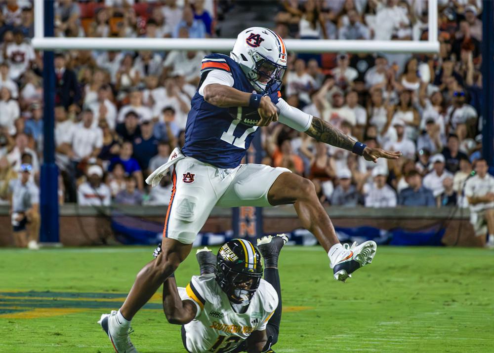 Auburn quarterback Byrum Brown leaps over a Southern Miss defender during Auburn’s 43-8 victory at Jordan-Hare Stadium.