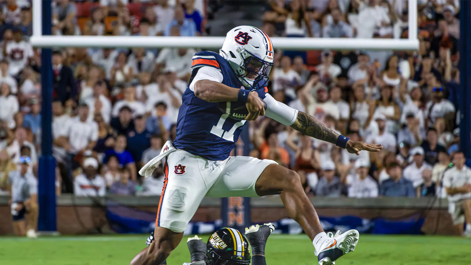 Auburn quarterback Byrum Brown leaps over a Southern Miss defender during Auburn’s 43-8 victory at Jordan-Hare Stadium.