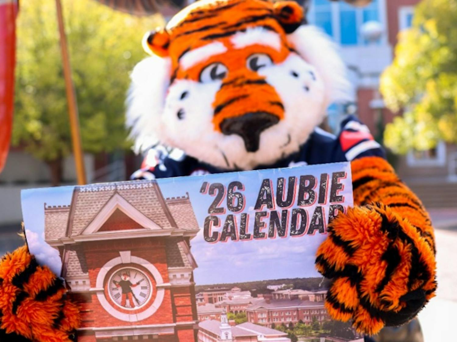 Aubie the Tiger holding up 2026 Aubie-themed calendar