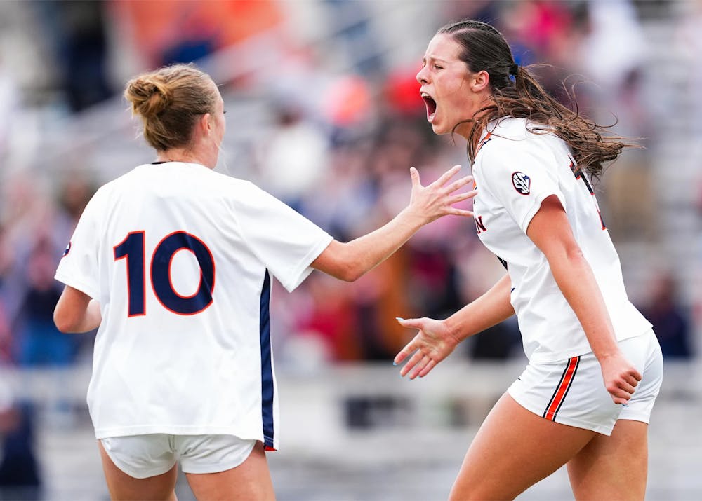 Auburn soccer players Dylan Driver and Gavey Ivey celebrate during a match, with Driver screaming as she reaches toward Ivey, who wears No. 10.