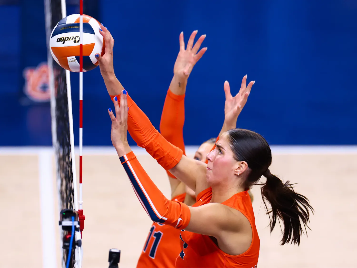 Auburn outside hitter Lauren Dreves (No. 2) reaches for the ball at the net.