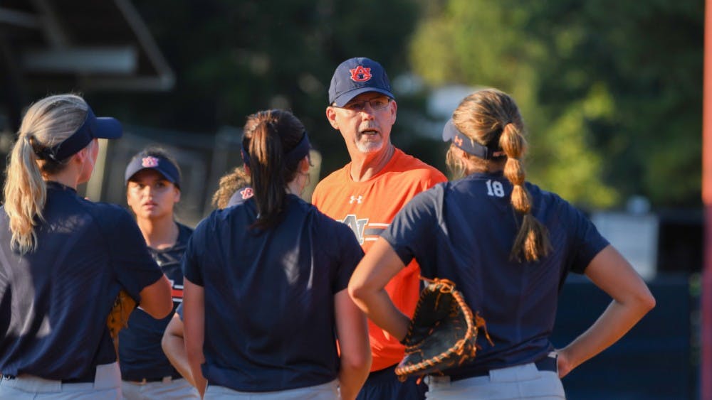 ​Mickey Dean talks to players during fall practices
