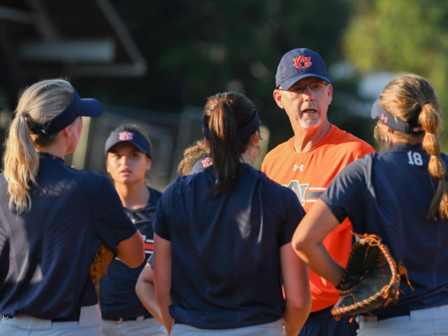 ​Mickey Dean talks to players during fall practices