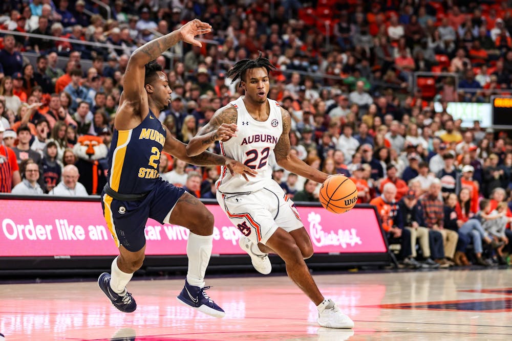 Dec 22, 2021; Auburn, AL, USA; Allen Flanigan (22) drives the ball in during the game between Auburn and Murray State at Auburn Arena . Mandatory Credit: Jacob Taylor/AU Athletics