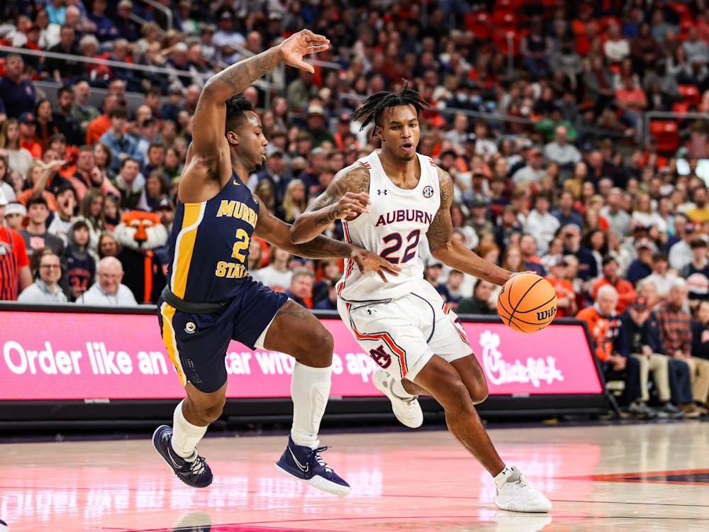 Dec 22, 2021; Auburn, AL, USA; Allen Flanigan (22) drives the ball in during the game between Auburn and Murray State at Auburn Arena . Mandatory Credit: Jacob Taylor/AU Athletics