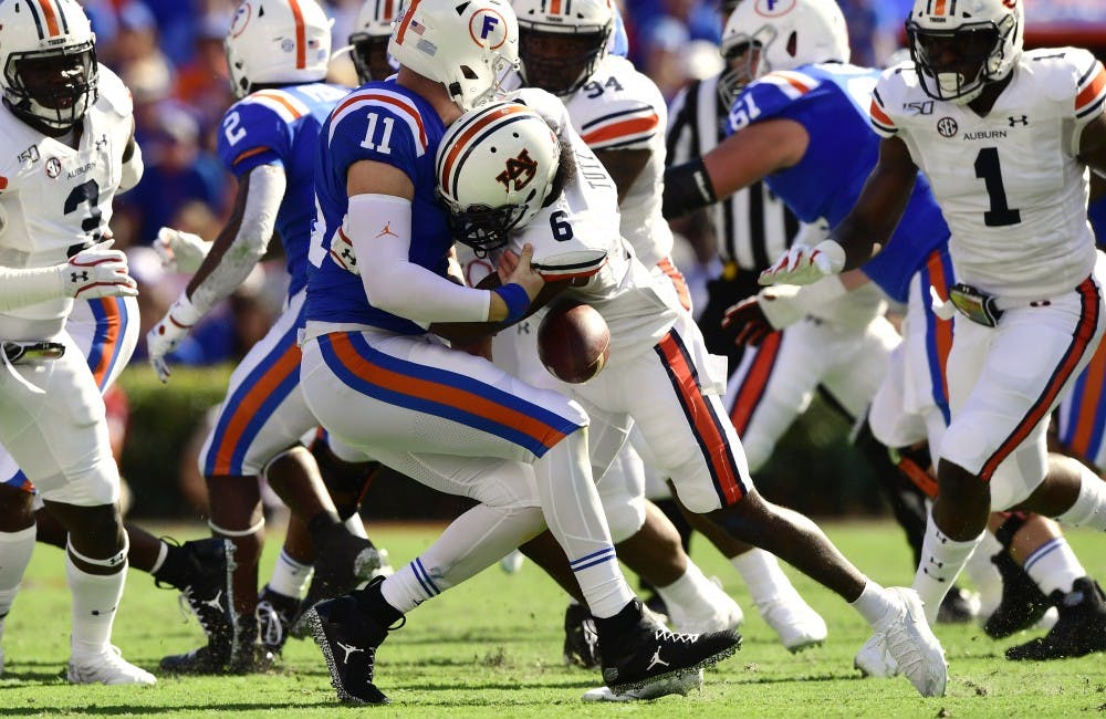 Christian Tutt (6) sacks Florida qb Trask Kyle and forces a fumble in the first ahlf.Auburn football at Florida on Saturday, Oct. 5, 2019 in Gainesville, FLTodd Van Emst/AU Athletics