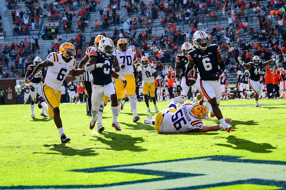 Oct 3, 2020; Auburn AL, USA; Christian Tutt (6) runs the ball for a touchdown during the game between Auburn and LSU at Jordan Hare Stadium. Mandatory Credit: Shanna Lockwood/AU Athletics