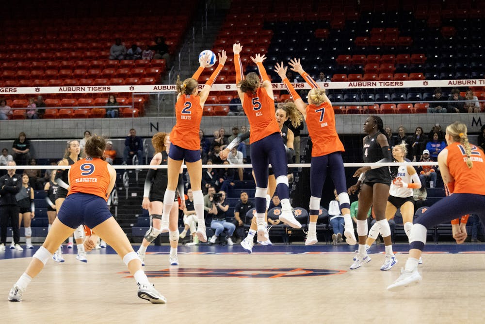 Lauren Dreves (2), Bella Bell (5) and Peyton Dunn (7) attempt to block the ball against Florida on Nov. 20, 2024 at Neville arena.

Estela Munoz, The Auburn Plainsman