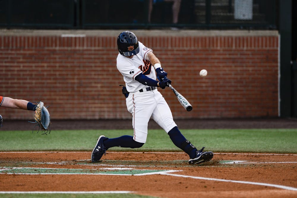 March 17, 2022; Auburn, AL, USA; Kason Howell (5) hits the ball during the game between Auburn and Ole Miss at Plainsman Park. Mandatory Credit: Jacob Taylor/AU Athletics