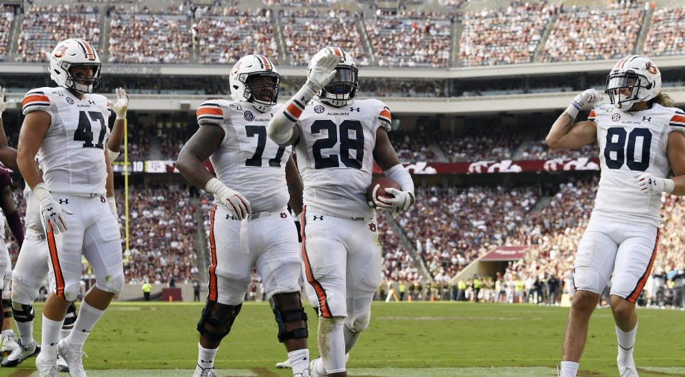John Samuel Shenker (47), Marquel Harrell (77), JaTarvious Whitlow (28) and Sal Cannella (80) celebrate Whitlow's score.Auburn vs Texas A&M on Saturday, Sept. 21, 2019 in College Station, TX.Todd Van Emst/AU Athletics