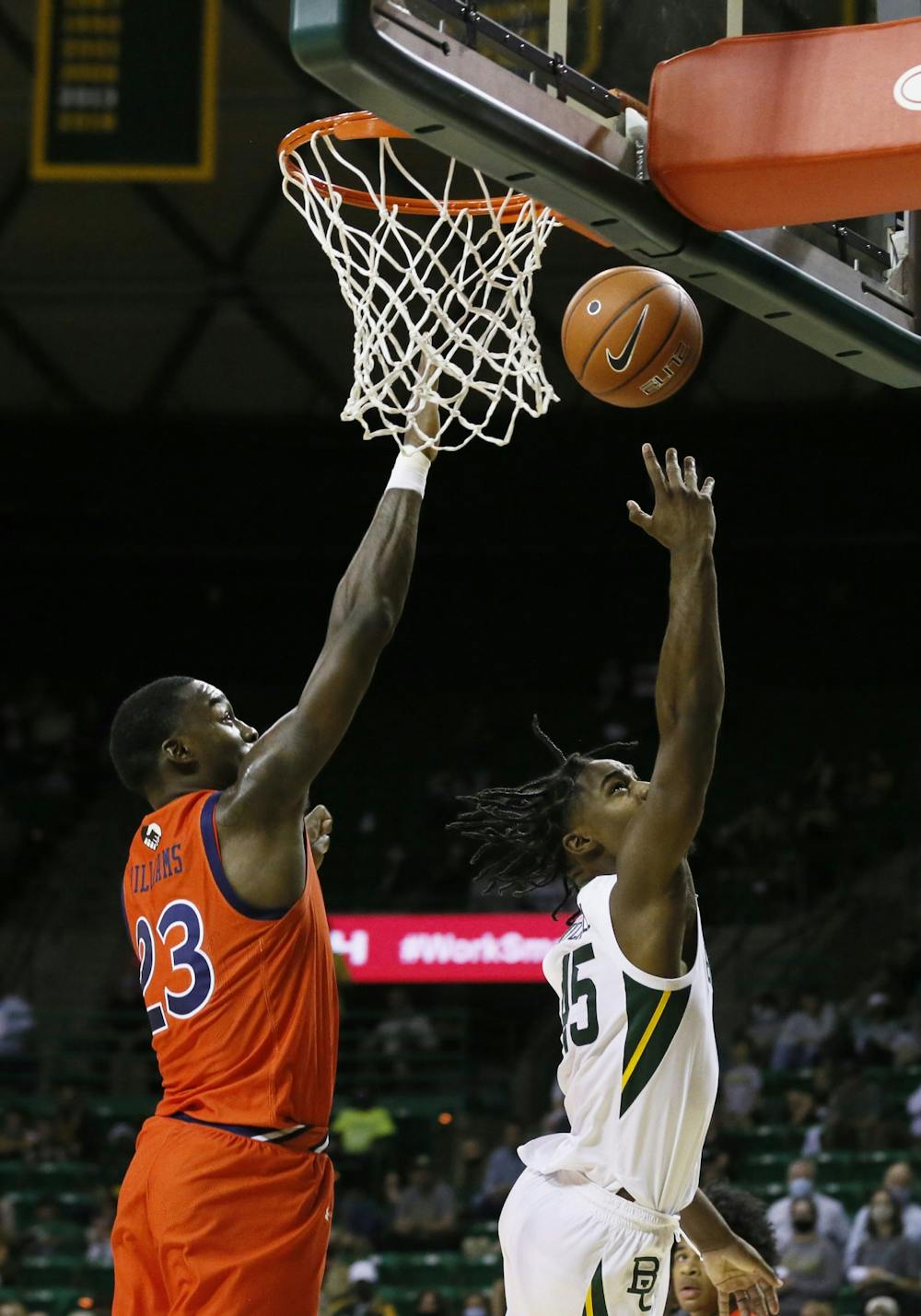 Jan 30, 2021; Waco, Texas, USA; Baylor Bears guard Davion Mitchell (45) throws the shot up against Auburn Tigers forward Jaylin Williams (23) during the first half at Ferrell Center. Mandatory Credit: Raymond Carlin III-USA TODAY Sports