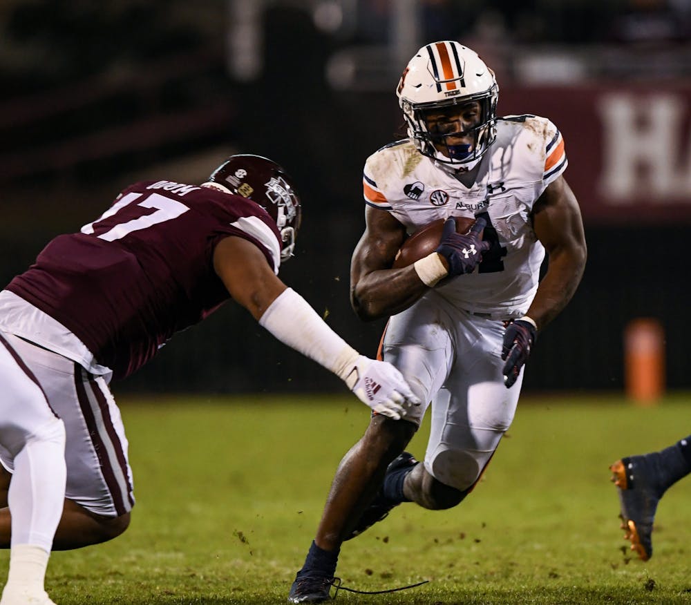 Oct 3, 2020; Starkville, Mississippi, USA; Tank Bigsby (4) avoiding tackle during the game between Auburn and Mississippi State at Davis Wade Stadium. Mandatory Credit: Todd Van Emst/AU Athletics
