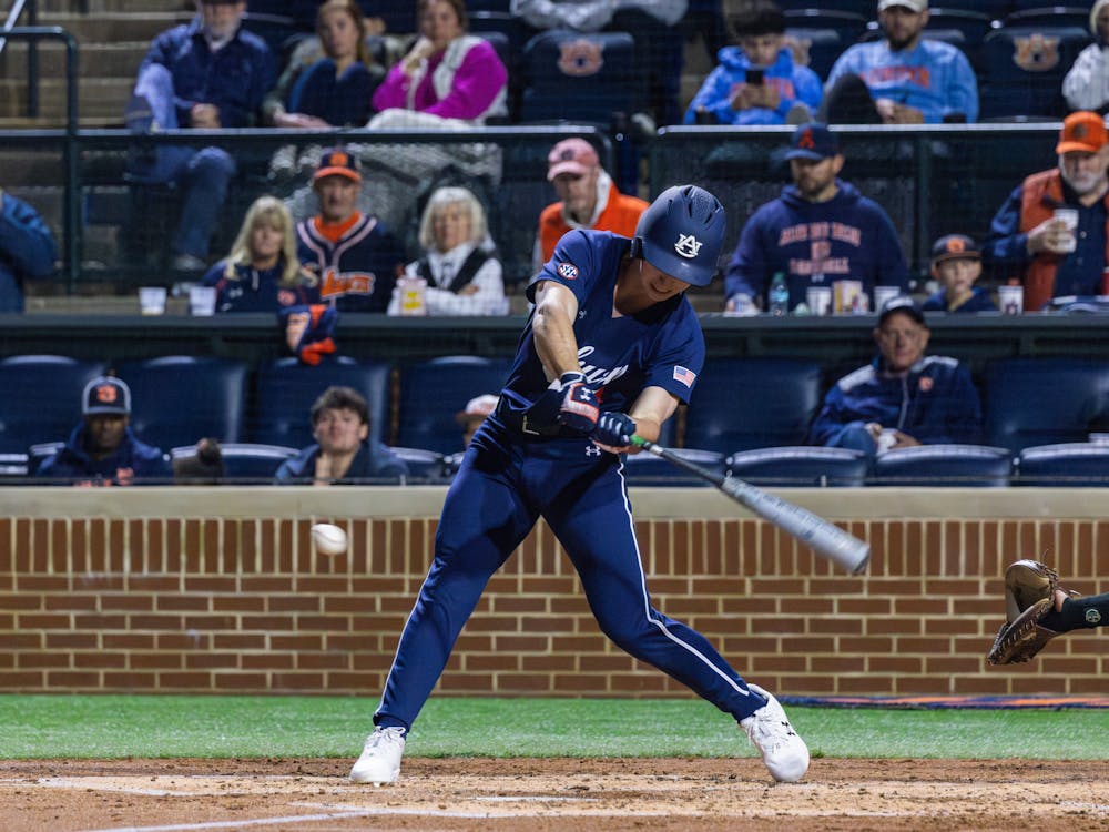 Center fielder Cade Belyeu fights off a single for his first at-bat of the season on Feb. 14, 2025. Photo by Luca Flores | The Auburn Plainsman