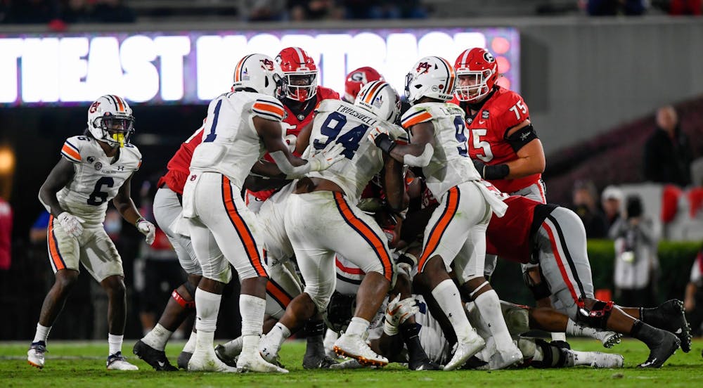 Oct 3, 2020; Athens, GA, USA; Defensive line stopping the run during in the second half between Auburn and Georgia at Samford Stadium. Mandatory Credit: Todd Van Emst/AU Athletics