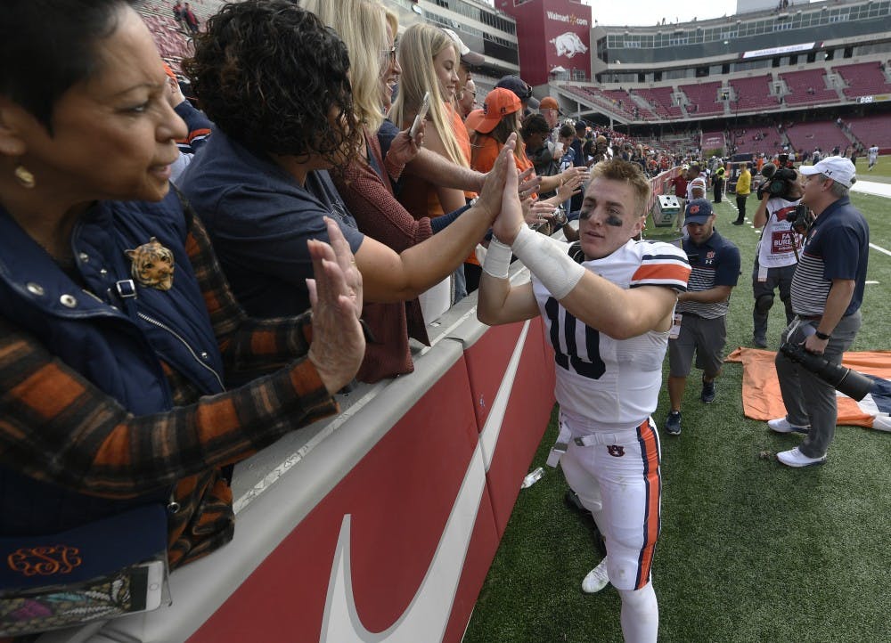 Bo Nix celebrates with fans after the game.Auburn football vs Arkansas on Saturday, Oct. 19, 2019 in Fayetteville, AK.Todd Van Emst/AU Athletics