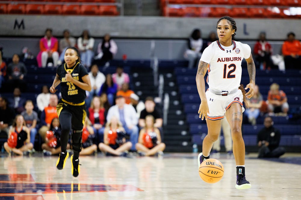 <p>Mar'shaun Bostic runs the ball down court against Alabama State on Dec. 21, 2024. Photo by Estela Munoz | The Auburn Plainsman</p>