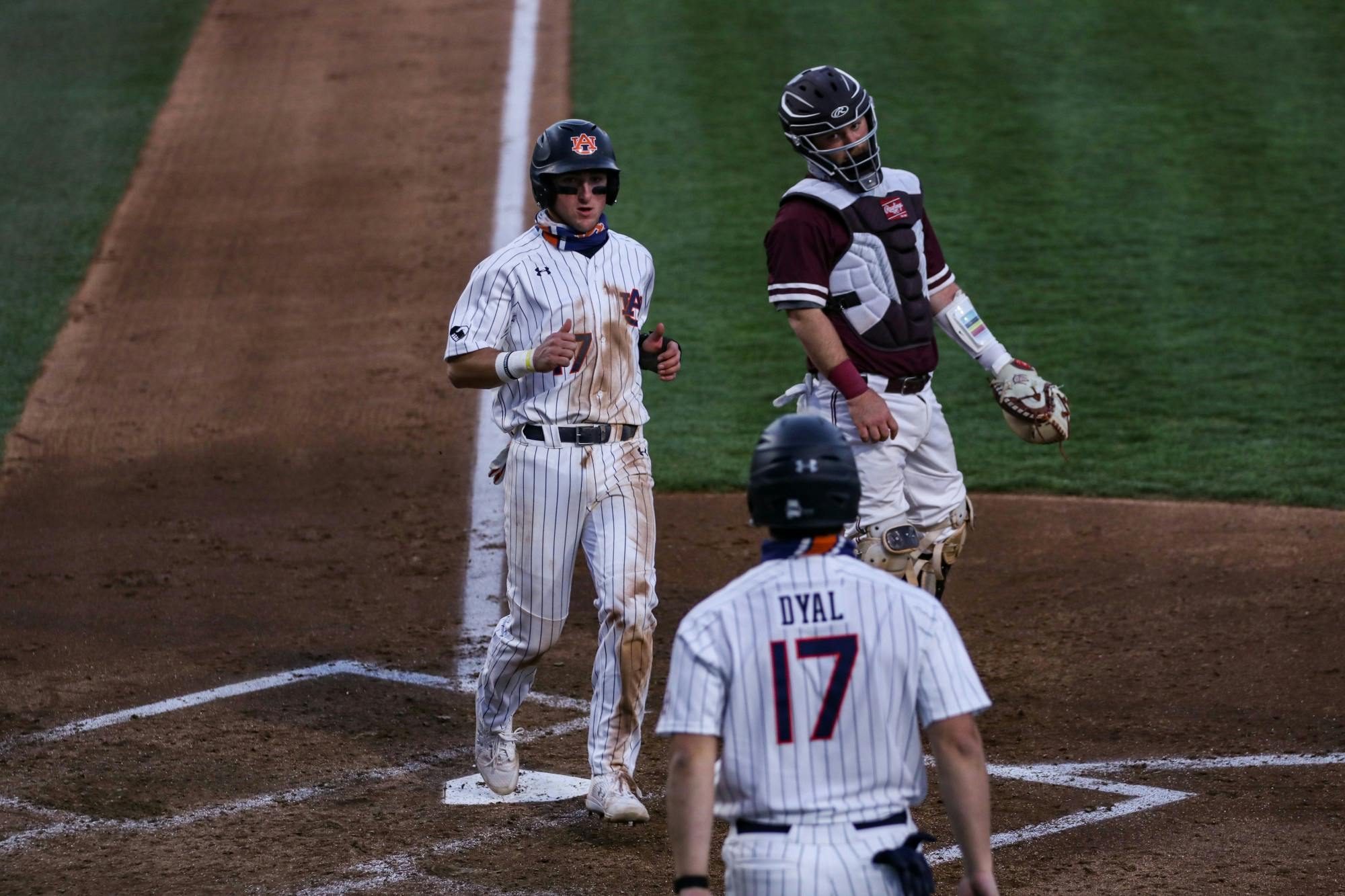 022421_Auburn_IMG_0535_Garrett Farquhar gets to home plate .jpg