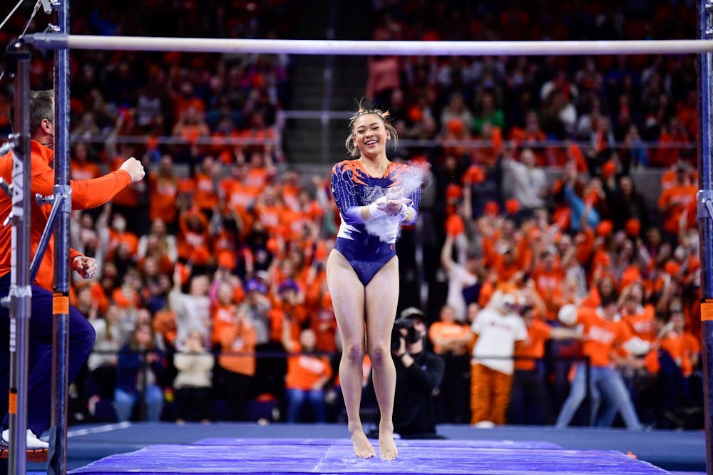 Jan 28, 2022; Auburn, AL, USA; Sunisa Lee reacts after her bars routine during the meet between Auburn and Alabama at Auburn Arena. Mandatory Credit: Matthew Shannon/AU Athletics