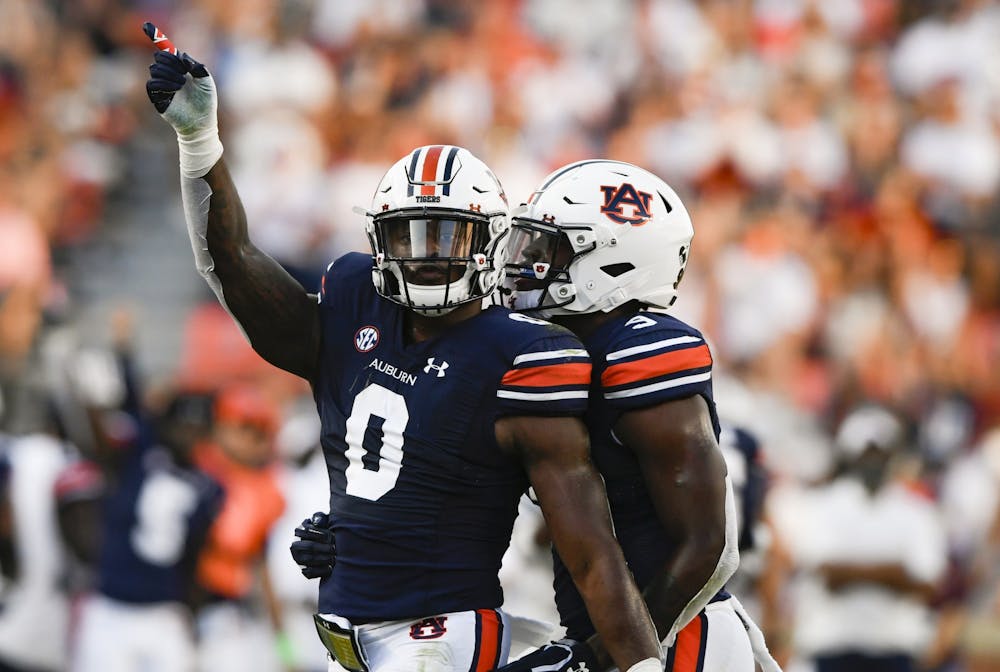 Aug 31, 2021; Auburn, AL, USA; Owen Pappoe (0) reacts with Zakoby McClain (9) between Auburn and Akron at Jordan-Hare Stadium. Mandatory Credit: Todd Van Emst/AU Athletics