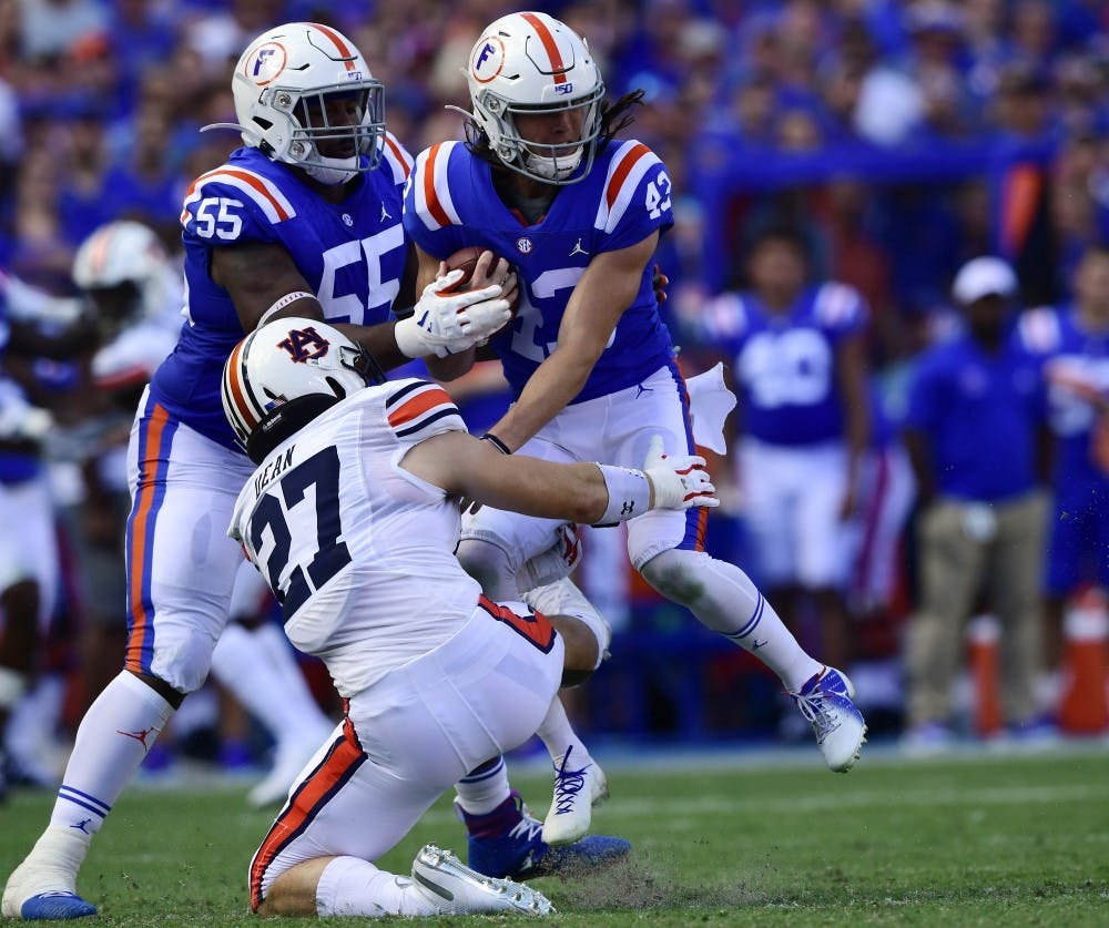 Tanner Dean (27) tackles Florida punter Tommy Townsend running a fake punt in the first half.Auburn football at Florida on Saturday, Oct. 5, 2019 in Gainesville, FLTodd Van Emst/AU Athletics