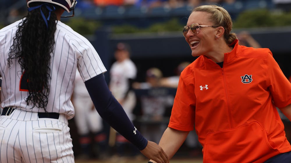 Auburn co-head coach Kate Malveaux celebrates with Auburn utility Ma'Nia Womack (photo by Riley Kelton)