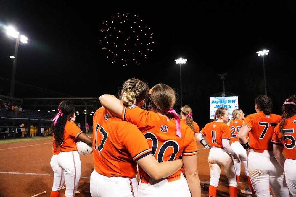<p>Maia Engelkes (17) and Aspyn Godwin (00) watch fireworks at Jane B. Moore Field after the Tigers beat Missouri on March 27, 2023.</p>