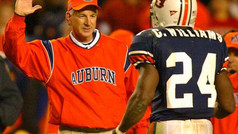 Tommy Tuberville giving a high-five to Carnell "Cadillac" Williams in 2004
Photo by AL.com